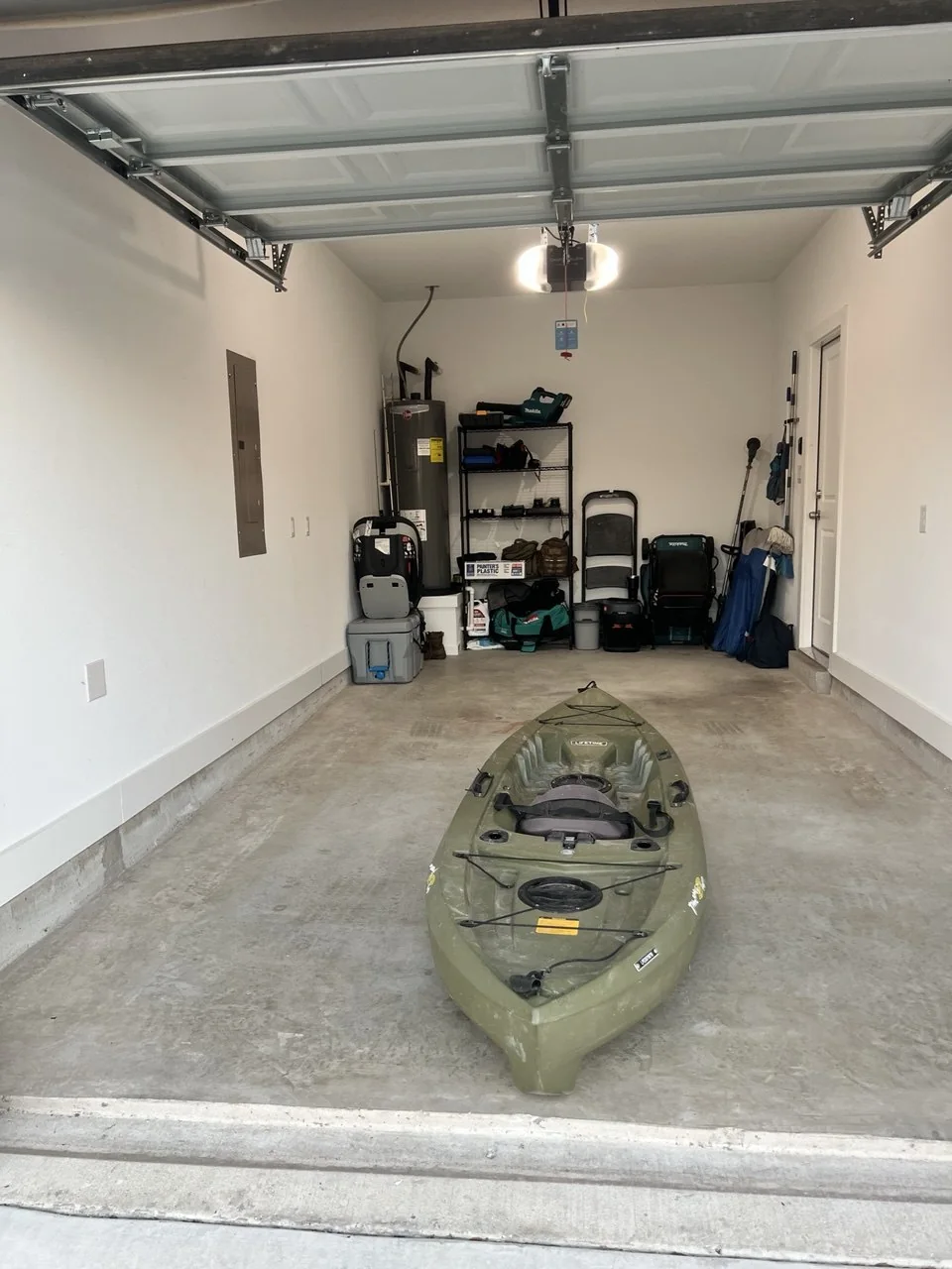 Garage reset with kayak staged in open floor space